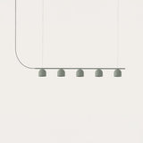 Rio 9 Linear 5 Light Dome Chandelier in green, five small dome shades on a slim iron rail suspended by fine wires, shown against a plain white background.