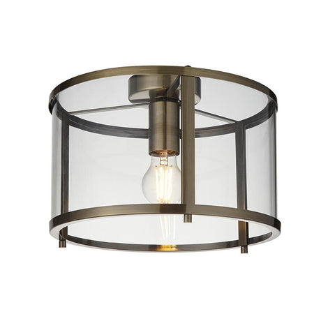Endon Ellery flush ceiling light in brass with a cylindrical clear glass shade and single E27 exposed filament bulb, shown on a plain white background.