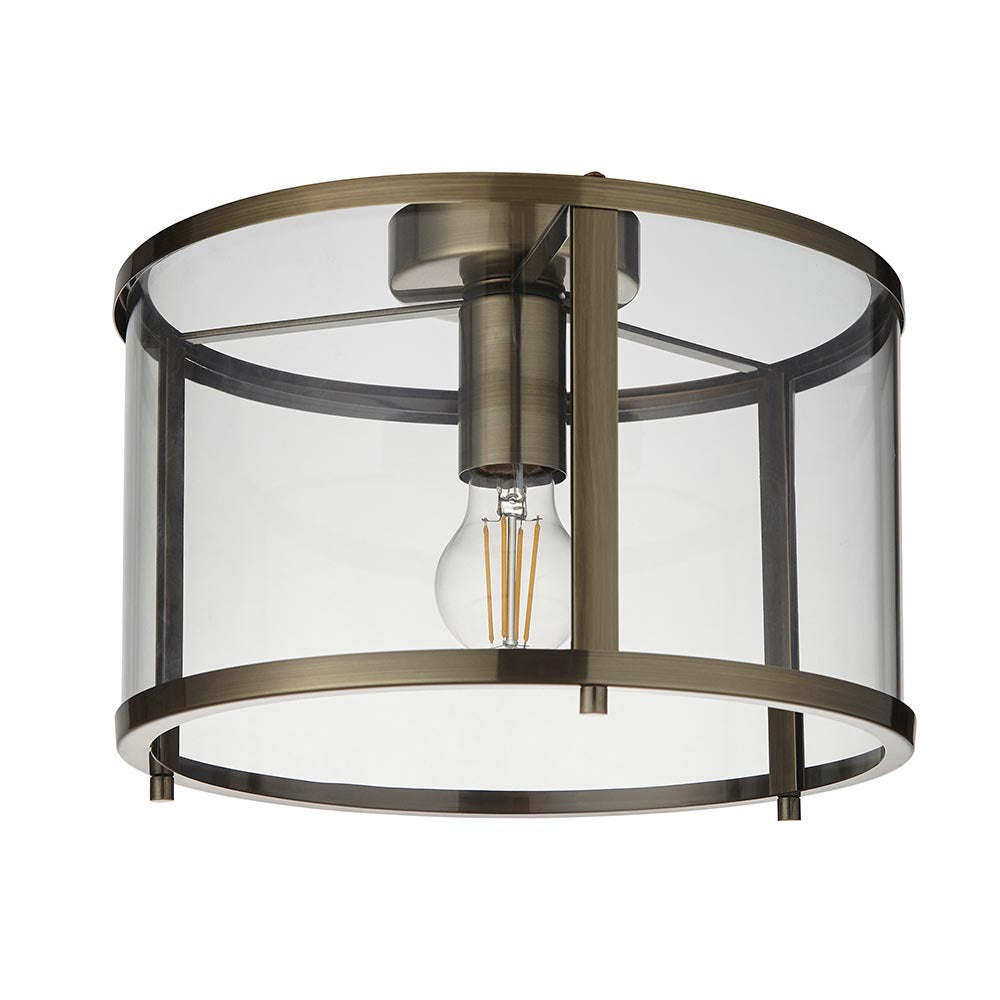 Endon Ellery flush ceiling light in brass with a cylindrical clear glass shade and single E27 filament bulb, shown on a plain white background.