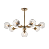 Endon Georgiana 8 light semi-flush pendant with spiral-cut clear glass globe shades on an antique brass frame, shown against a white background.