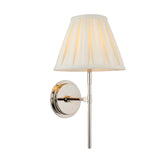 Endon Chartwell wall light with tapered box-pleat cream cotton shade and polished nickel bracket, shown illuminated against a plain white background.
