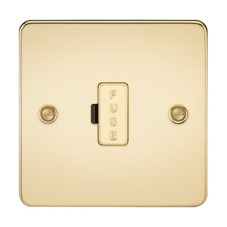 The 13A Fused Spur Unit in polished brass showcases a centrally positioned rectangular button marked FUSE on a sleek flat plate with rounded edges. This elegant fused spur features two visible screws for easy installation.