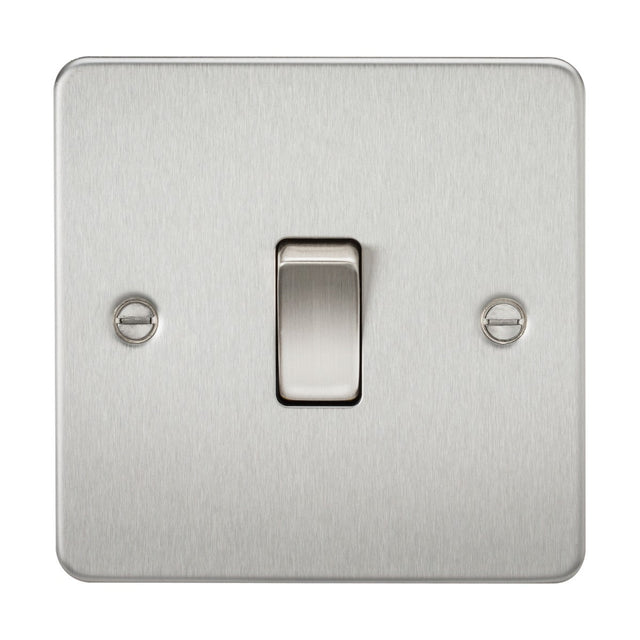 The image highlights the 10AX 1 Gang Intermediate Switch - Brushed Chrome (Flat Plate) mounted on a wall, emphasizing its brushed chrome finish and flat plate design. This stainless steel switch includes an intermediate control and is accented by two visible screws that enhance its sleek and minimalist look.