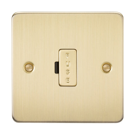 The 13A Fused Spur Unit - Brushed Brass (Flat Plate) showcases an ultra-low profile design with two visible screws and FUSE elegantly engraved on the central switch.
