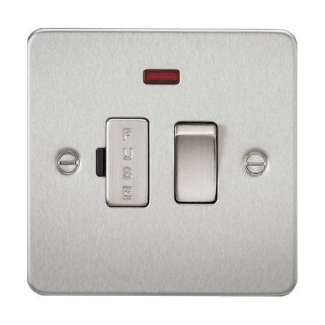 The 13A Switched Fused Spur Unit Neon - Brushed Chrome (Flat Plate) showcases a toggle switch on a brushed chrome panel with a low-profile design. It includes a small red neon indicator light above the switch, and the prominently labeled FUSE slot is integrated into the stylish flat plate design with two visible screws.