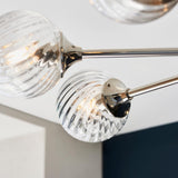 Close-up of Endon Georgiana pendant showing spiral-cut clear glass globe shades on nickel-plated arms fixed to the ceiling.