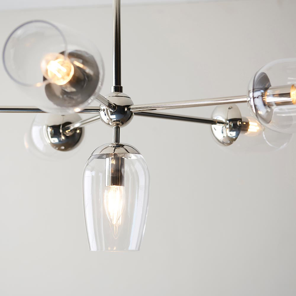 Endon Caldworth 6 light pendant in polished nickel, close-up of curved arms with clear blown glass shades and a central tulip-shaped downlight.