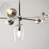Endon Caldworth 6 light pendant in polished nickel, close-up of curved arms with clear blown glass shades and a central tulip-shaped downlight.