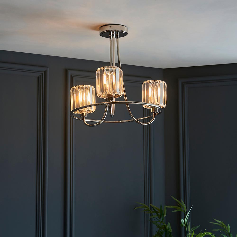 Clementine 3 Light Semi-Flush Ceiling Light in nickel with crystal-effect glass shades, shown against dark panelled walls in a living space.