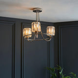 Clementine 3 Light Semi-Flush Ceiling Light in nickel with crystal-effect glass shades, shown against dark panelled walls in a living space.