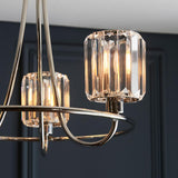 Clementine 3-light nickel semi-flush ceiling light with curved arms, faceted crystal-effect glass shades, and exposed bulbs, shown against a dark panelled wall.