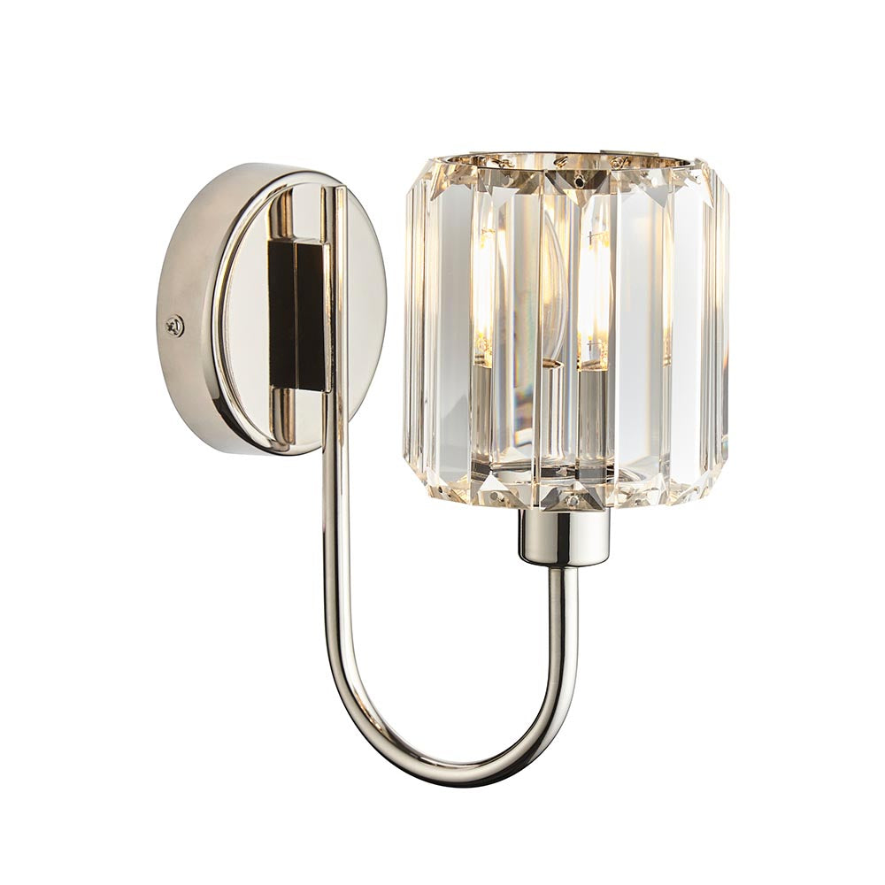 Endon Clementine wall light in nickel with a single faceted clear glass shade on a curved plated metal arm and round backplate, on a white background.