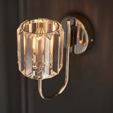 Endon Clementine wall light in nickel, single lit E14 lamp inside a cut faceted glass shade on a curved plated arm with round backplate.