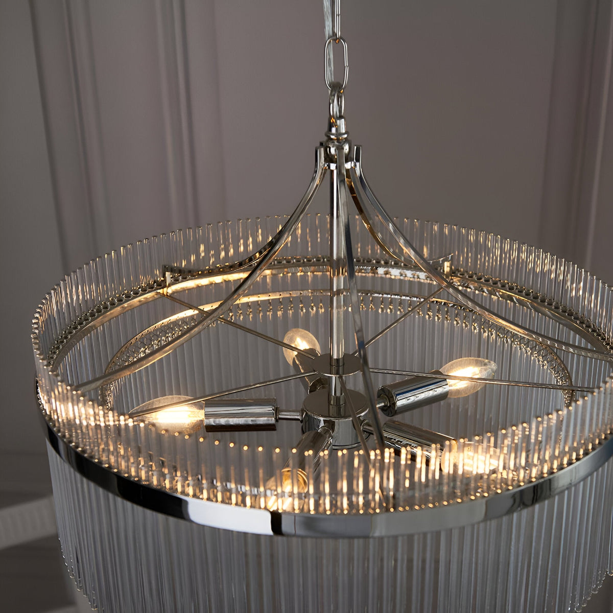 Beaumont 5 Light Pendant in nickel, close-up of the glass rod drum shade and central five-arm frame with lit bulbs, hung from a chain.