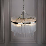 Beaumont 3 Light Pendant in nickel, a two-tier round fixture with clear glass rods and chain suspension, hanging against a panelled grey wall.
