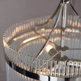 Beaumont 3 Light Pendant in nickel, close-up of clear glass rods framing the round frame with visible bulb and central chrome stem.