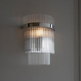 Endon Beaumont wall light in nickel with tiered clear glass rods and a polished chrome band, illuminated against a light grey wall.