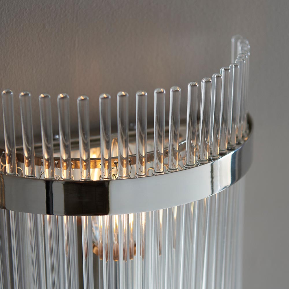 Close-up of Endon Beaumont wall light in nickel, showing polished chrome-effect band and clear glass rods glowing softly around a single E14 lamp.