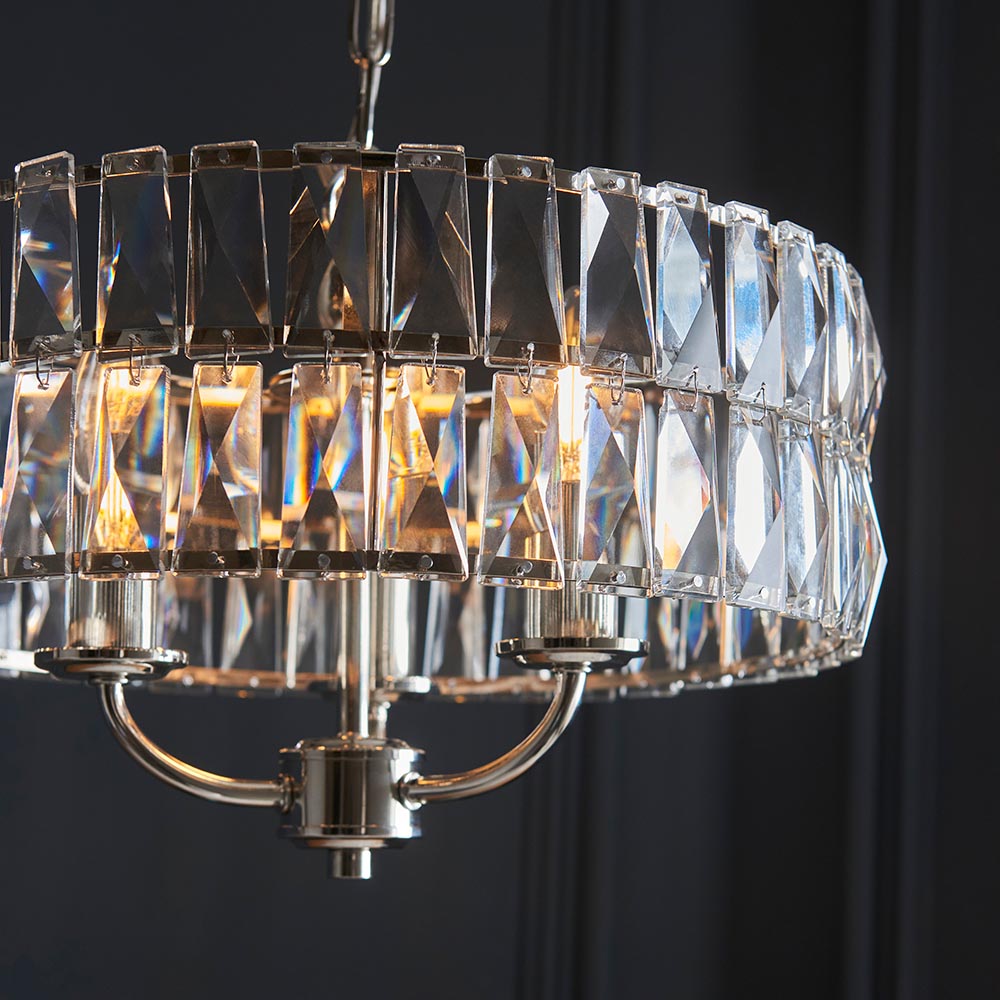 Bevmont 3 Light Pendant in nickel with faceted crystal glass panels around a drum frame and three curved arms holding candle-style bulbs.