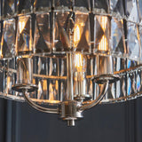Bevmont 3 Light Pendant in nickel with faceted glass panels and three exposed E14 bulbs on curved metal arms.