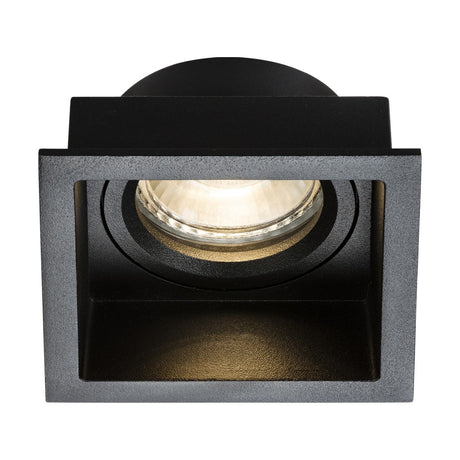 The Dipa Single Fixed Recessed Square Downlight in Black features a sleek black square design and a visible bulb, offering stylish and subtle lighting. Its anti-glare attributes boost its modern, minimalist appeal while providing a warm glow. The frame encases the bulb in a straightforward cubic form, making it an ideal choice for any space.