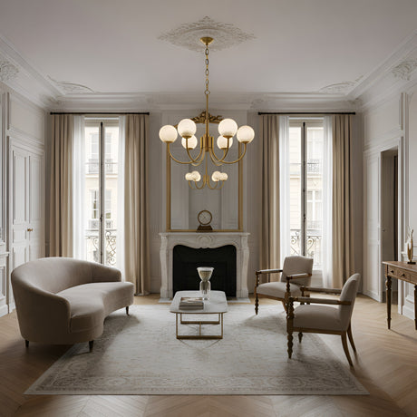 Elegant living room with two armchairs, a curved sofa, marble coffee table, and a decorative fireplace beneath the Aurelio 6 Light Globe Alabaster Chandelier in Soft White & Brushed Brass. Beige curtains frame large windows in this sophisticated space.