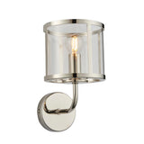 Ellery Wall Light in nickel with a cylindrical clear glass shade, single E14 bulb, curved arm and round backplate, on a plain white background.