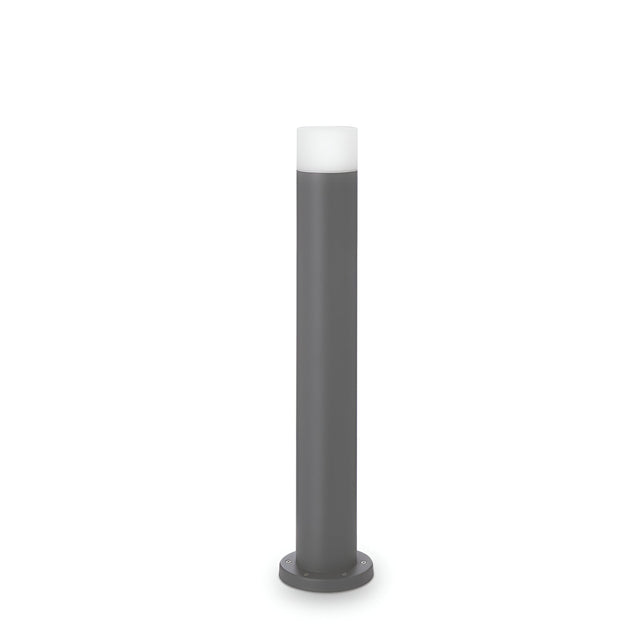 The Drape Outdoor Bollard Light - Grey, 60cm is a sleek, cylindrical fixture with a grey metal finish and a white frosted top. It boasts an energy-efficient bulb and stands upright on a round base against a plain white background.