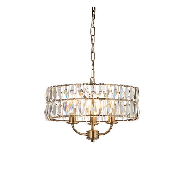 Endon Bevmont 3 light pendant in brass with a drum shade of clear cut faceted glass on a height adjustable chain, shown on a white background.