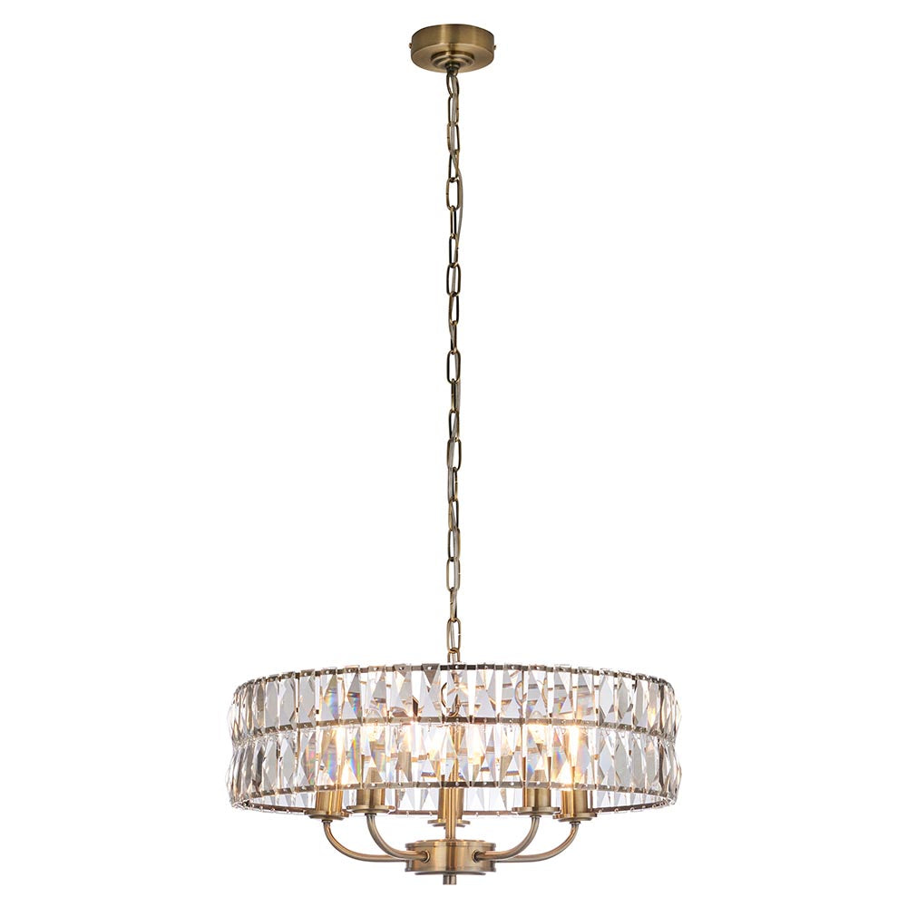 Bevmont 5 Light Pendant in antique brass with a drum-shaped frame of faceted crystal glass, suspended on an adjustable chain against a plain white background.
