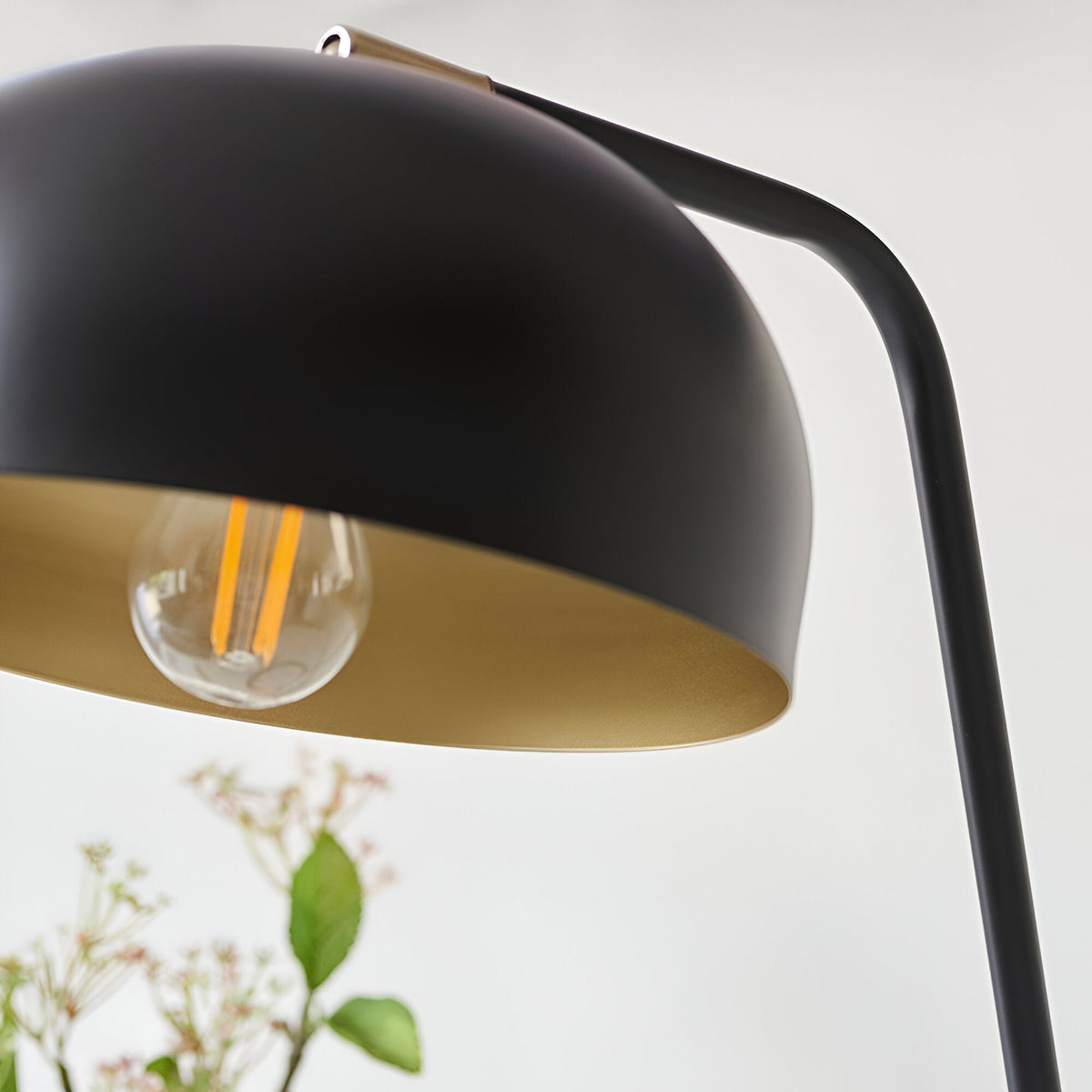 Ashdon Table Lamp in matt black with antique brass inner shade, close-up of angled dome head and E14 bulb against a plain white background.