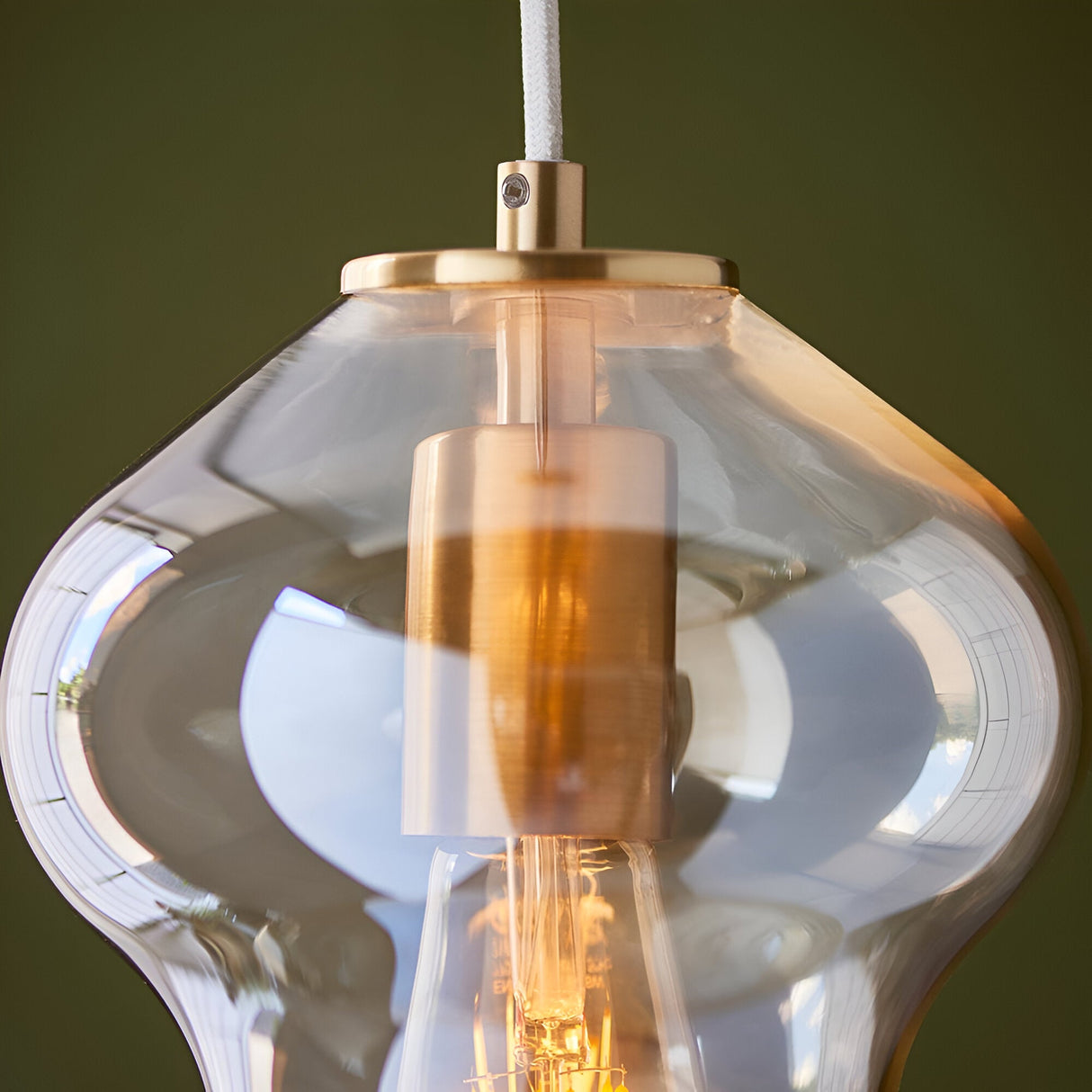 Close-up of the Brockley Pendant in Brass & Gold, showing a champagne lustre glass shade and satin brass fitting with visible E27 bulb holder.