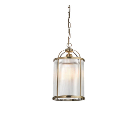 Endon Caldcombe small pendant light with a ribbed clear glass cylindrical shade and antique brass frame, suspended from a chain on a plain background.