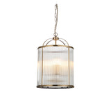 Endon Caldcombe pendant light with clear ribbed glass shade on an antique brass cylindrical frame, suspended from a chain against a white background.