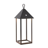 Endon Brenmont large table lamp in matt black, a modern bird-house lantern with pyramid roof, loop handle and open aluminium frame on a plain background.