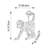 Belvoir Table Lamp in black resin, shaped as a walking monkey with an exposed bulb holder on its tail, shown with dimension labels H37.5cm, D39.5cm, W13.5cm.