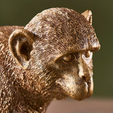 Close-up of the Endon Belvoir table lamp showing the detailed resin monkey head and ears in a warm vintage gold finish.
