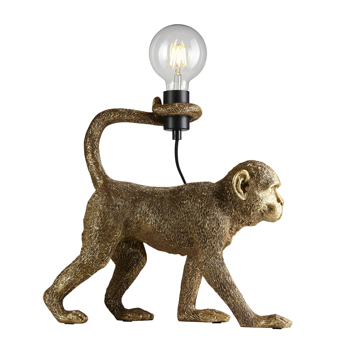Endon Belvoir table lamp shaped as a walking gold resin monkey holding an exposed filament bulb with its tail, shown on a white background.