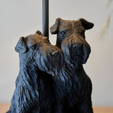 Danegrove Table Lamp base close-up showing two textured resin dog figures in matt black, with lamp pole visible against a plain light background.