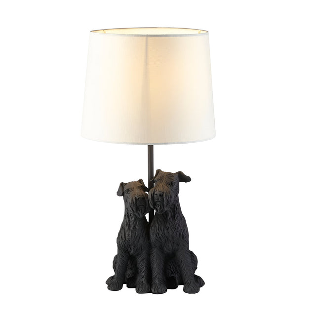 Danegrove Table Lamp in matt black resin, featuring two detailed dog figures at the base with a white fabric drum shade, on a plain white background.