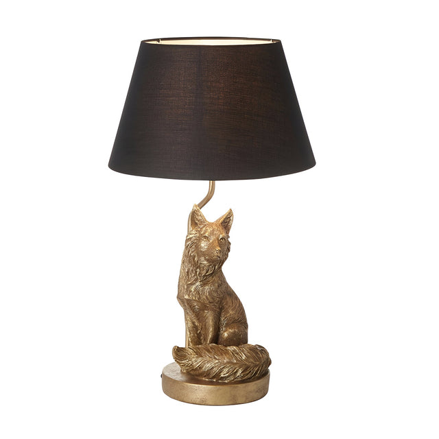 Endon Brambury table lamp with a vintage gold resin fox base and bushy tail on a round plinth, topped with a black tapered fabric shade.