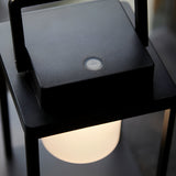 Close-up of the Endon Danedon table lamp showing the matt black square top with touch dimmer button and warm white polycarbonate diffuser below.