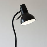 Endon Alderton floor lamp in matt black with an adjustable gooseneck stem, curved handle and bell-shaped GU10 head, shown against a light grey background.