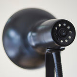 Close-up of the Endon Alderton Floor Lamp in matt black, showing the rocker switch and vented rear of the adjustable head above the flexible stem.