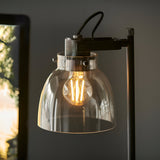 Endon Camden industrial task table lamp with adjustable head, smoked grey glass shade, matt black metalwork, knurled details and lit E27 filament bulb.
