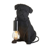 Endon Charthurst table lamp shaped as a matt black resin pug figure with an E14 filament bulb holder at its chest, on a plain white background.