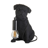 Endon Charthurst matt black resin table lamp shaped as a seated pug, with an E14 filament bulb in a black holder and fabric cable, on a white background.
