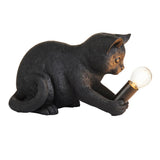 Endon Brockwick table lamp shaped as a matt black resin kitten holding an E14 filament bulb in its paws, shown on a plain white background.