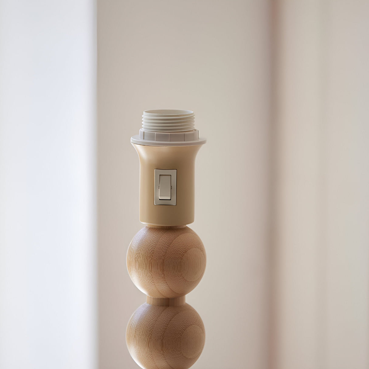 Close-up of the Endon Ashwood floor lamp showing the E27 lamp holder with on/off switch above a natural bamboo sphere.