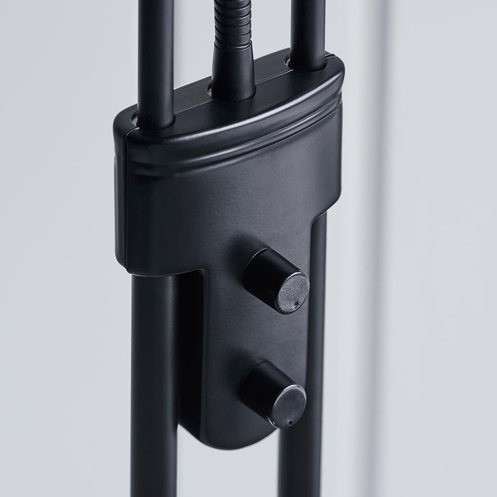 Close-up of the Endon Cliffcombe floor lamp showing the matt black stem with dual rotary dimmer switches for the uplighter and reading arm.